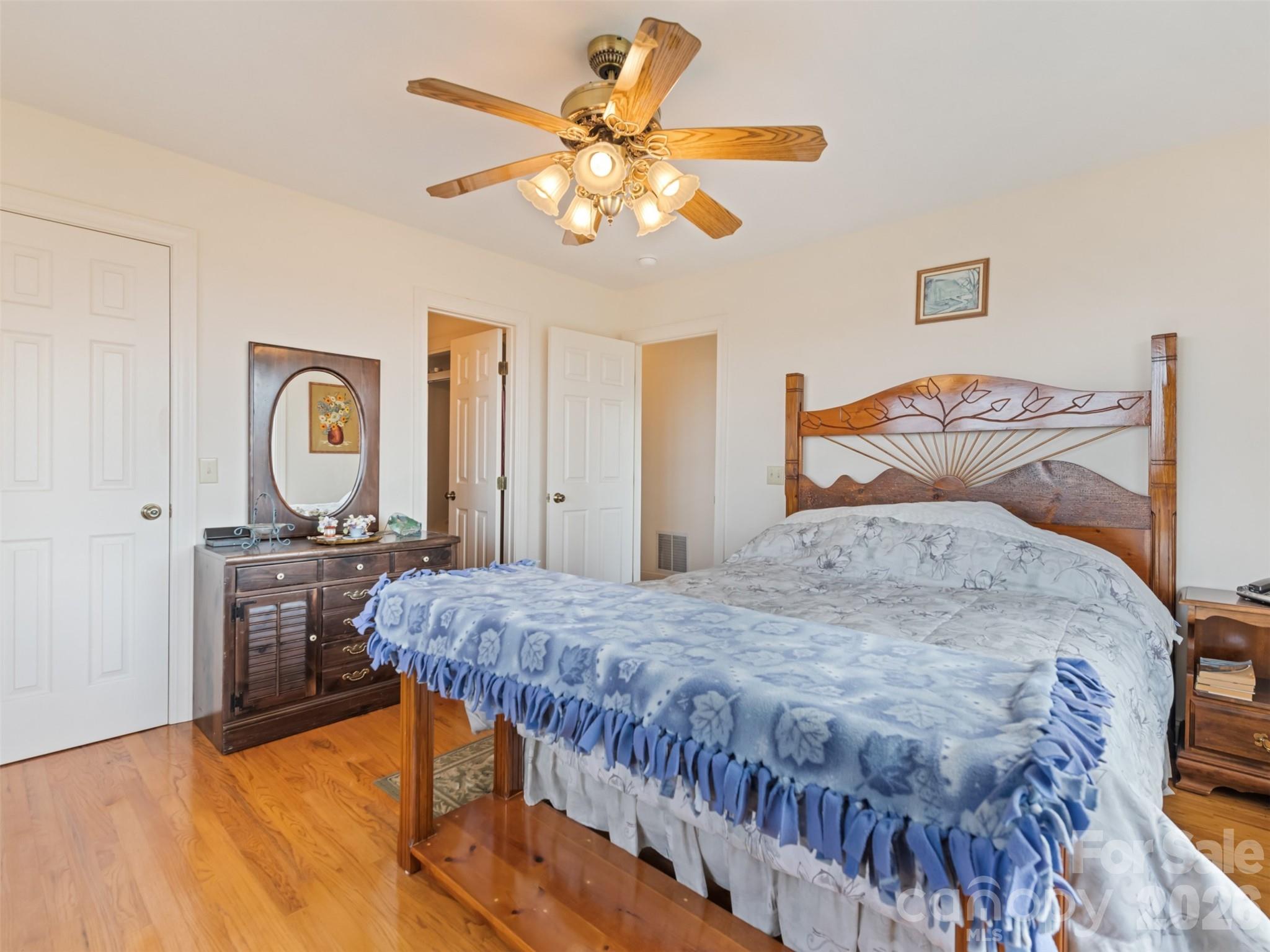 1007 Turkey Trot Road Clyde, NC 28721 - Photo 22 of 48 a bedroom with a bed and a chandelier