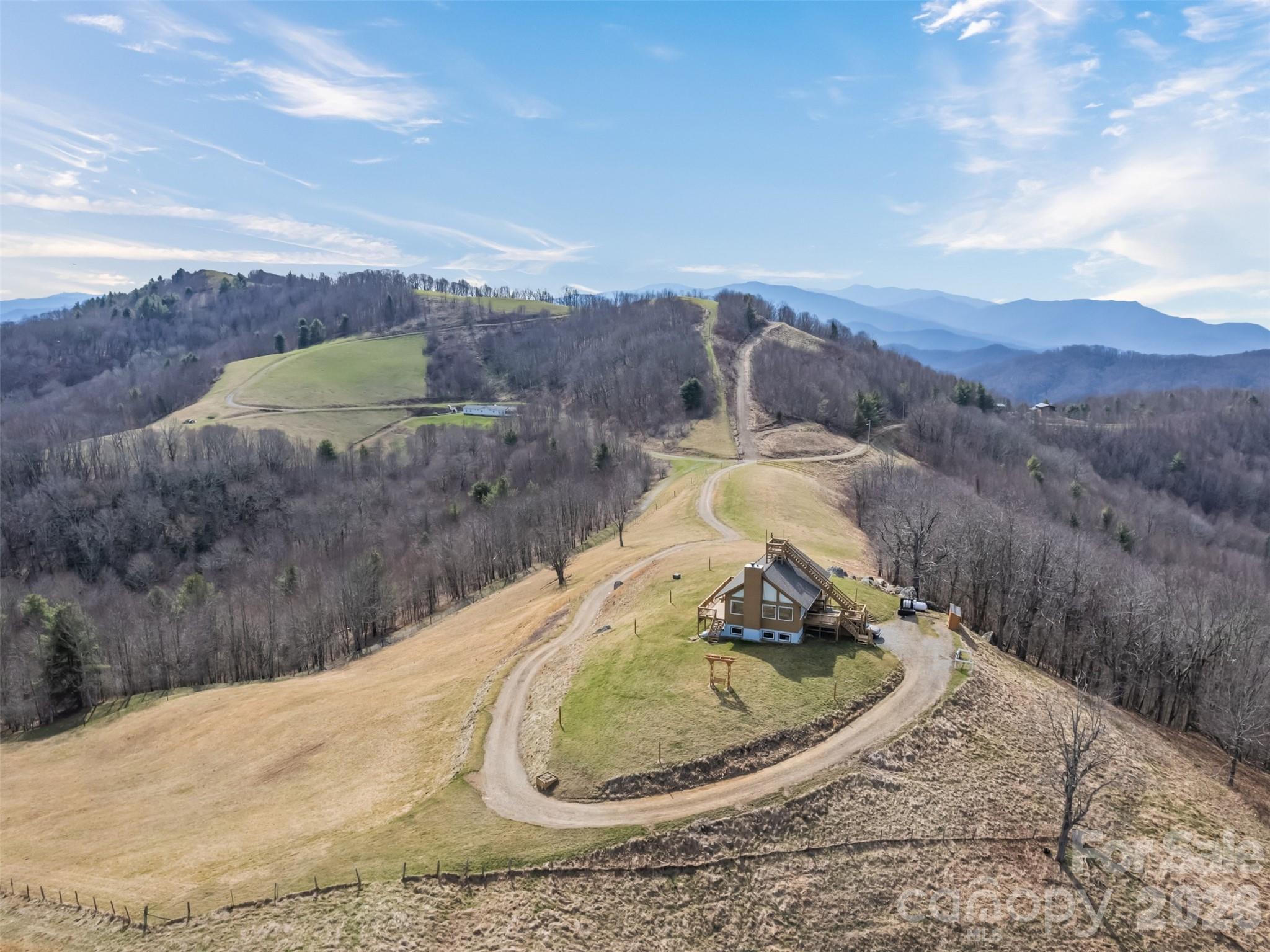 1007 Turkey Trot Road Clyde, NC 28721 - Photo 8 of 48 a view of a wooden house with a yard