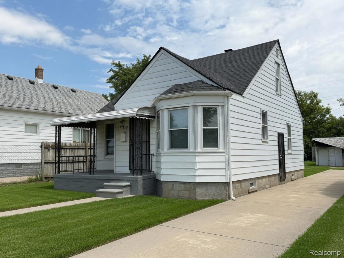 7286 Faust Avenue Detroit, MI 48228 - Photo 4 of 19 White siding exterior with a dark asphalt shingle roof