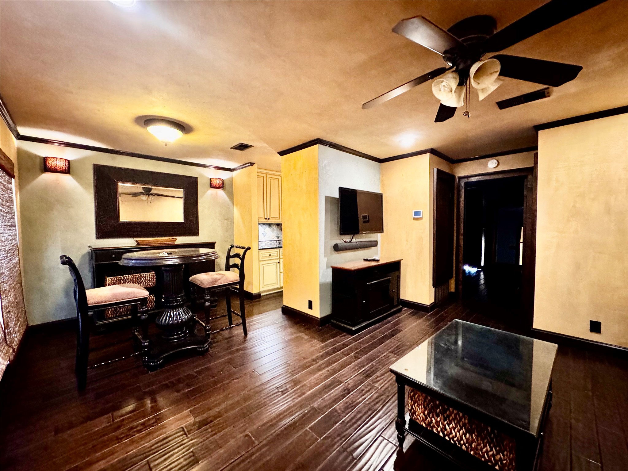 a living room with furniture and a flat screen tv