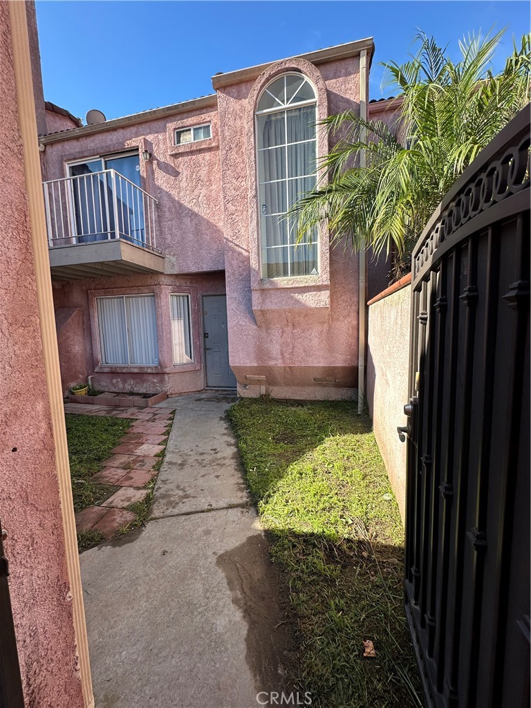 165 Racquet Club Drive Compton, CA 90220 - Photo 1 of 47 a front view of a house with a yard