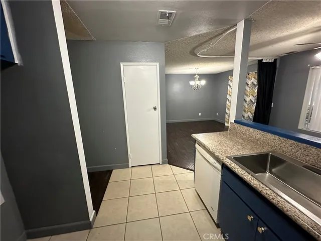 a kitchen with granite countertop a sink stove and refrigerator