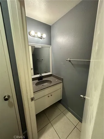 a bathroom with a sink a mirror and a vanity