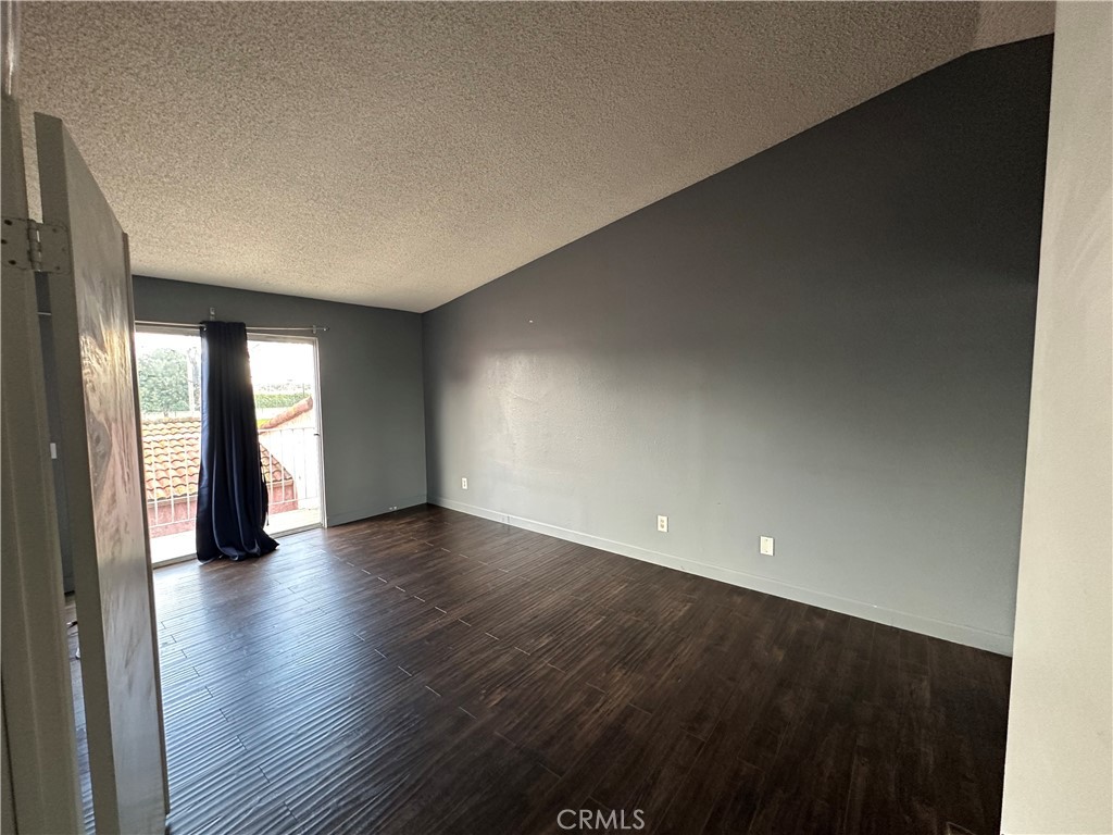 165 Racquet Club Drive Compton, CA 90220 - Photo 25 of 47 an empty room with wooden floor and windows
