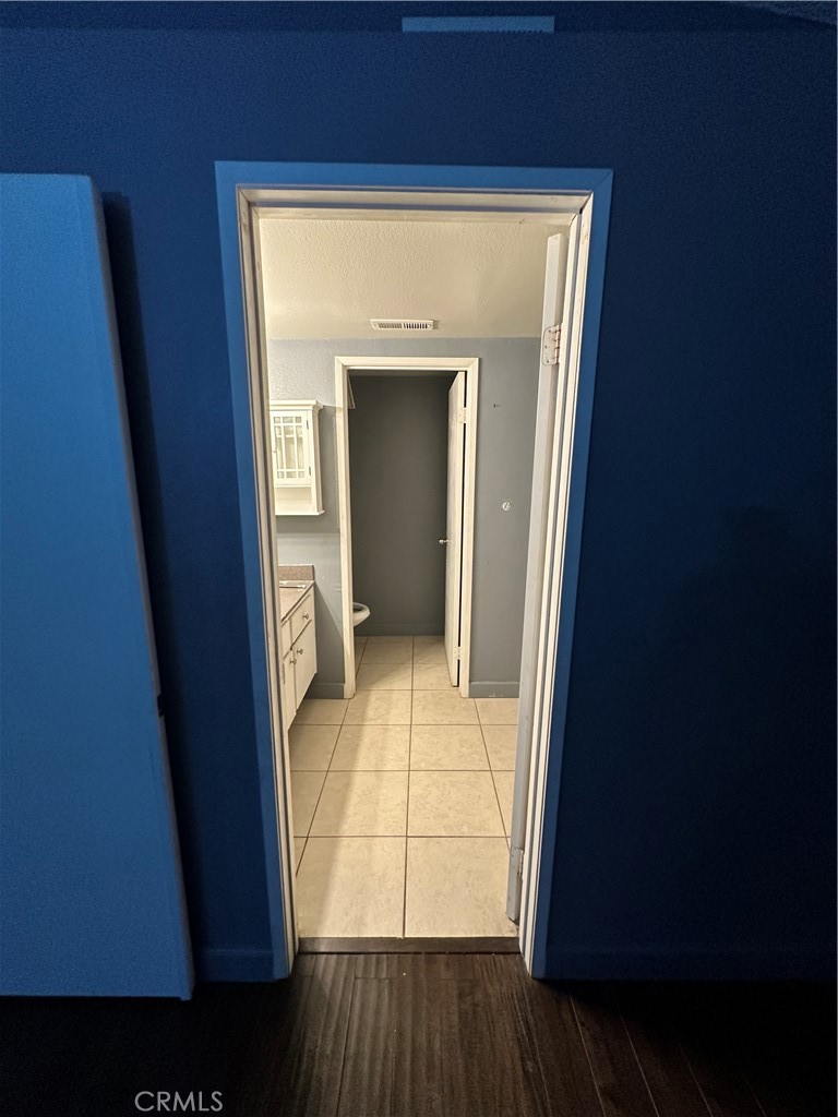 165 Racquet Club Drive Compton, CA 90220 - Photo 28 of 47 a view of an empty room with wooden floor and a window