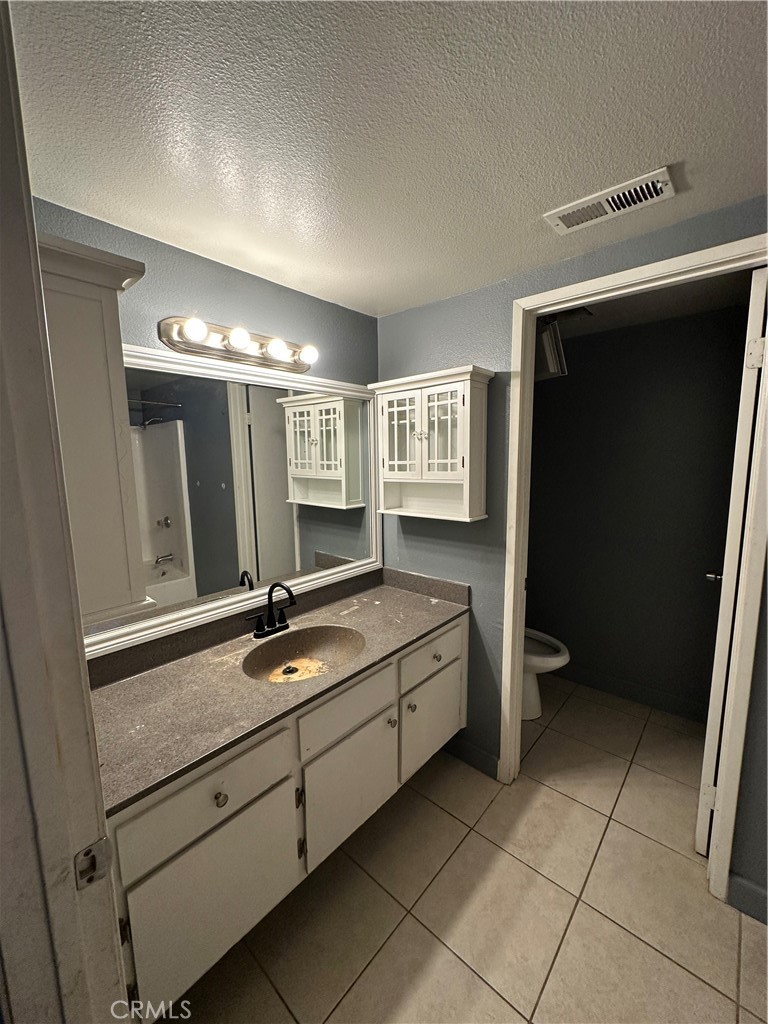 165 Racquet Club Drive Compton, CA 90220 - Photo 29 of 47 a bathroom with a double vanity sink and mirror