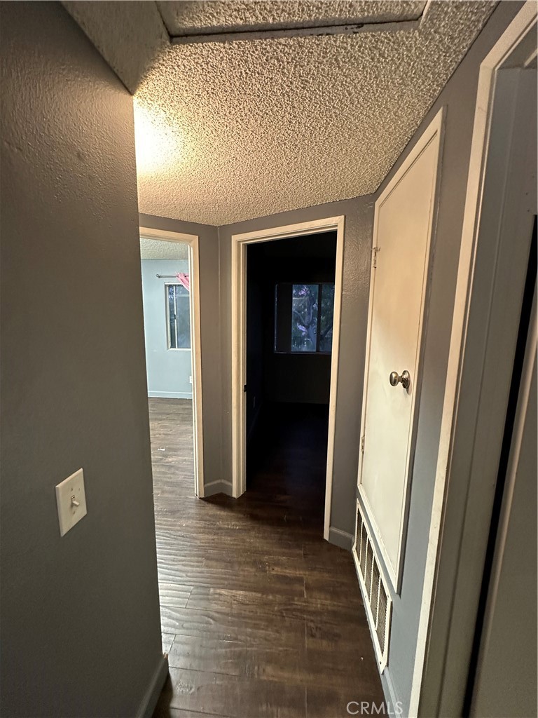 165 Racquet Club Drive Compton, CA 90220 - Photo 32 of 47 a view of a hallway with wooden floor and staircase