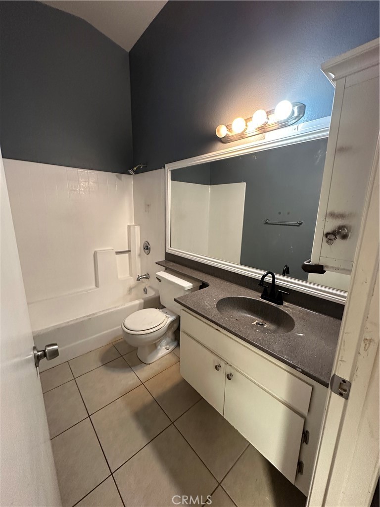 165 Racquet Club Drive Compton, CA 90220 - Photo 34 of 47 a bathroom with a granite countertop sink a toilet a mirror and vanity