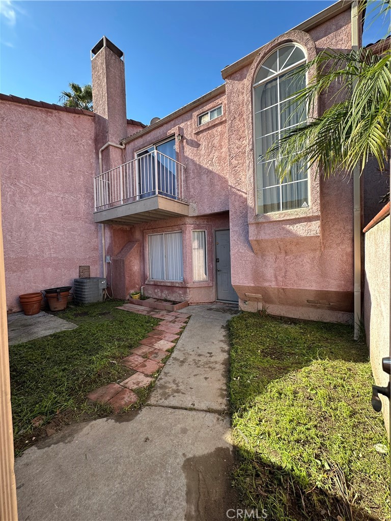 165 Racquet Club Drive Compton, CA 90220 - Photo 4 of 47 a front view of a house with a garden