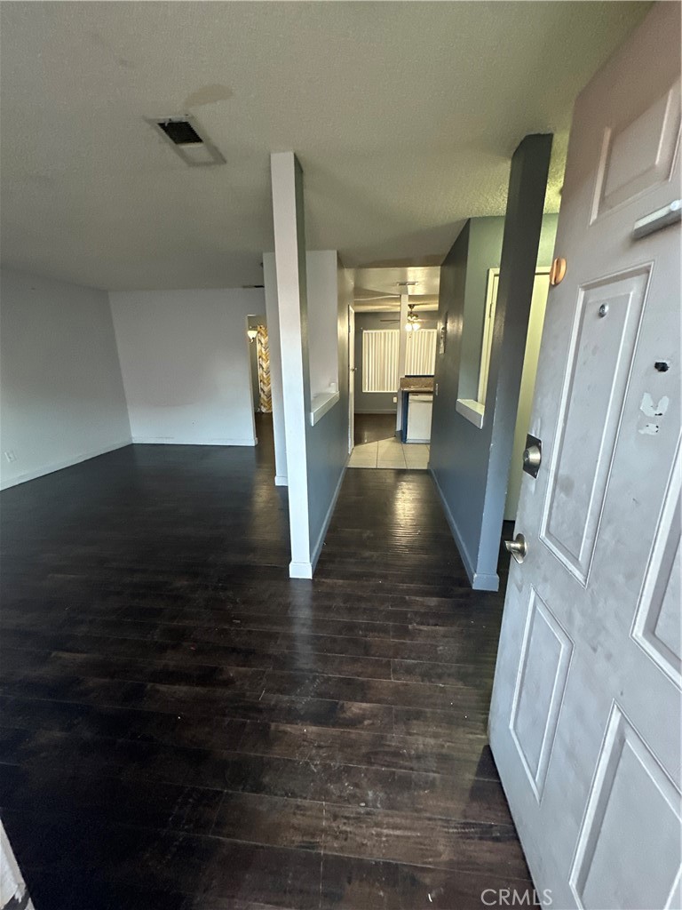 165 Racquet Club Drive Compton, CA 90220 - Photo 5 of 47 a view of a hallway view with wooden floor and staircase