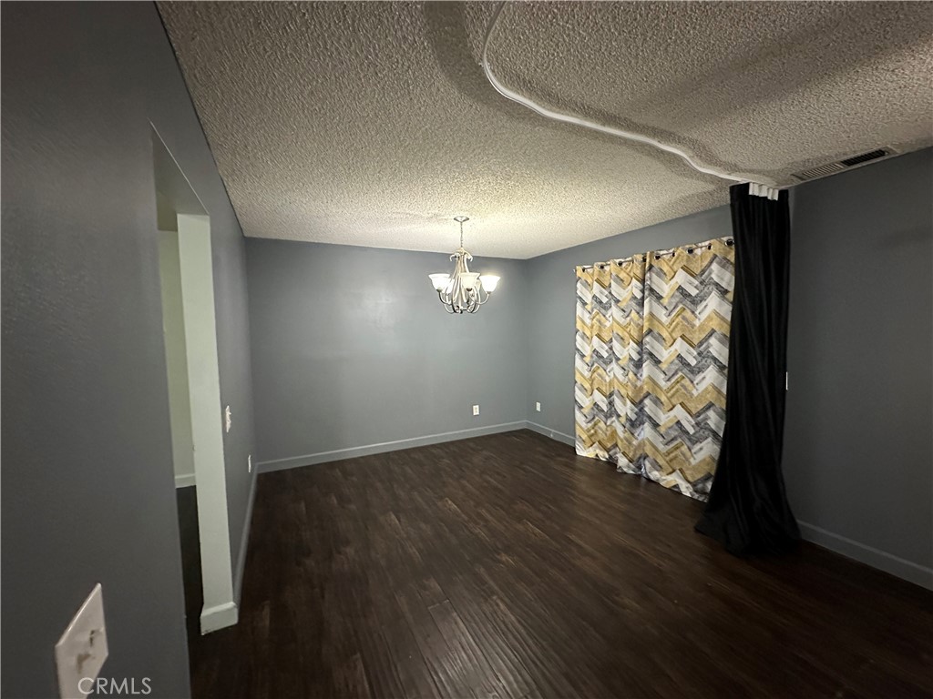 165 Racquet Club Drive Compton, CA 90220 - Photo 9 of 47 an empty room with wooden floor and windows