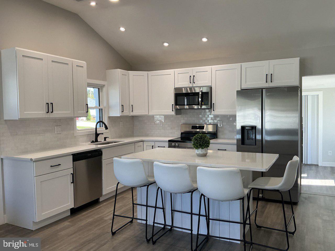 702 Beaumont Road Fairless Hills, PA 19030 - Photo 17 of 28 a kitchen with kitchen island granite countertop a sink cabinets and stainless steel appliances