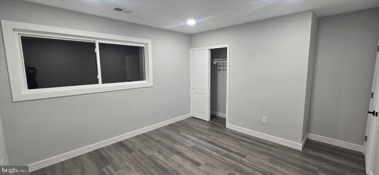 702 Beaumont Road Fairless Hills, PA 19030 - Photo 24 of 28 a view of an empty room with wooden floor and a window