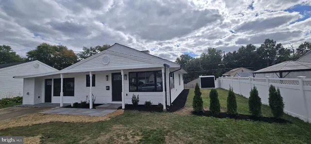 a view of a house with backyard porch and sitting area