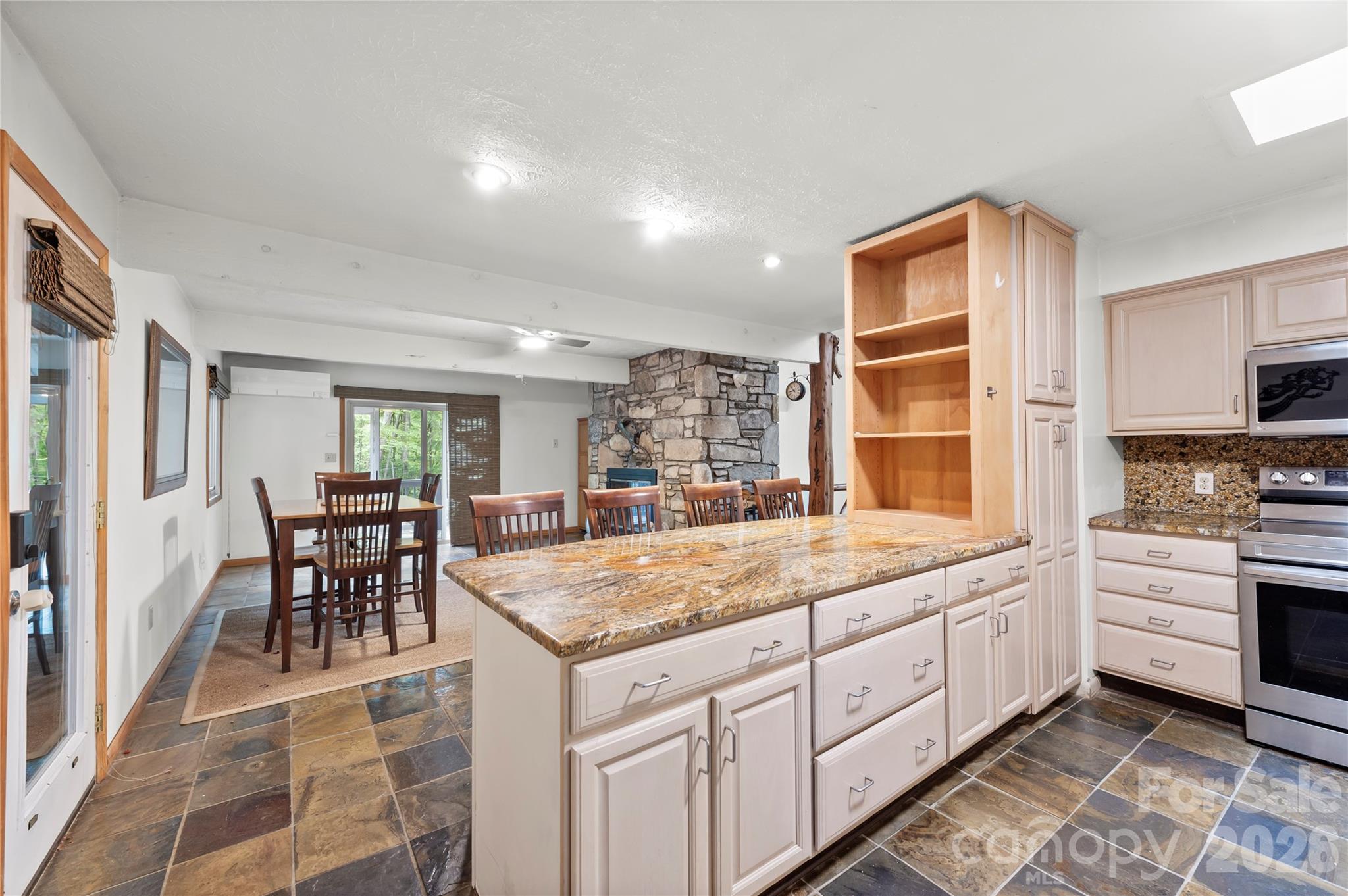 1483 Old Fort Road Fairview, NC 28730 - Photo 4 of 29 a kitchen with granite countertop kitchen island stainless steel appliances a stove a sink and a refrigerator