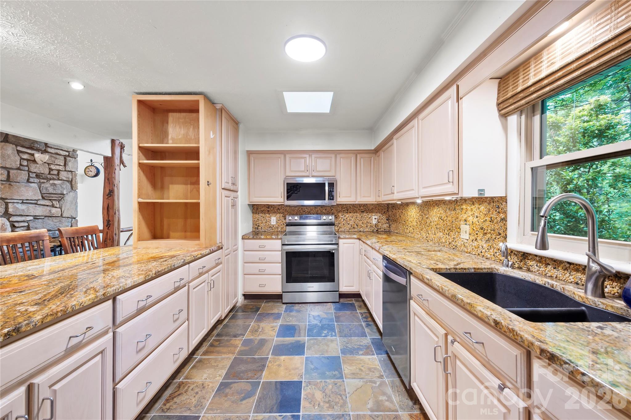 1483 Old Fort Road Fairview, NC 28730 - Photo 5 of 29 a large kitchen with a stove sink and cabinets