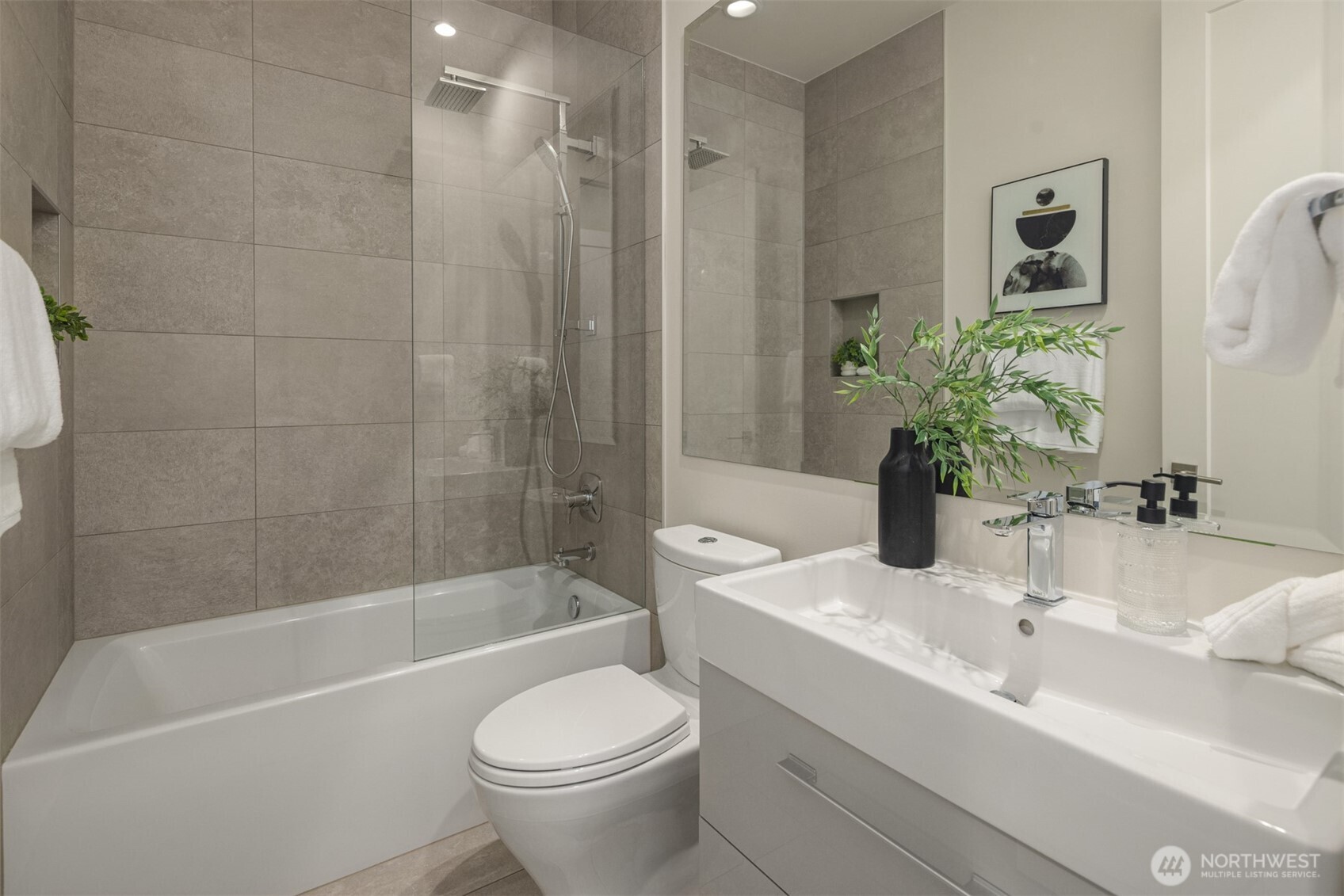 8926 Northeast 36th Street Yarrow Point, WA 98004 - Photo 30 of 40 a bathroom with a sink a toilet a mirror a bathtub and shower