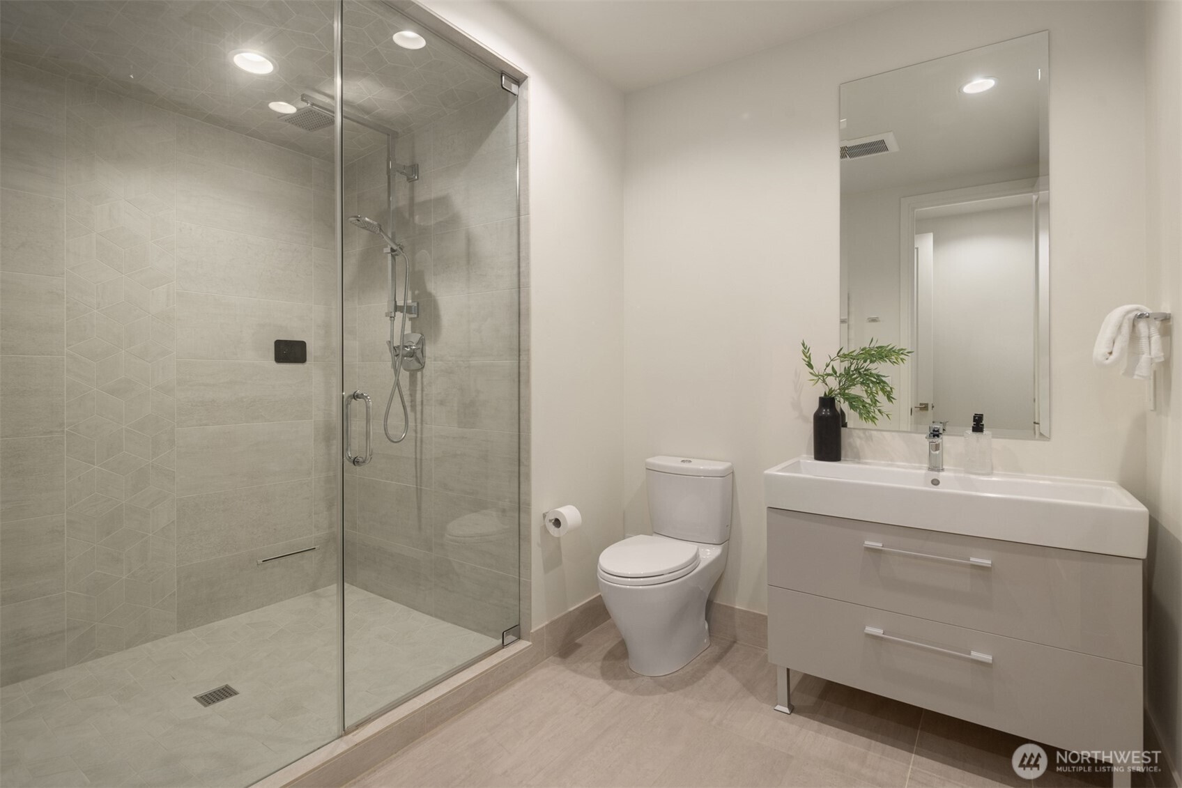 8926 Northeast 36th Street Yarrow Point, WA 98004 - Photo 33 of 40 a bathroom with a shower sink vanity mirror and toilet