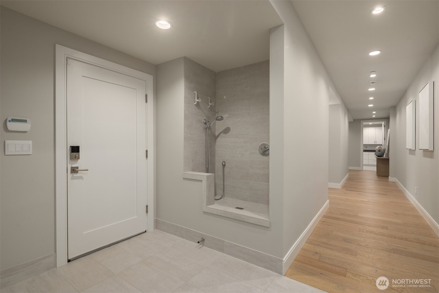 8926 Northeast 36th Street Yarrow Point, WA 98004 - Photo 37 of 40 a view of a hallway with wooden floor and a bathroom