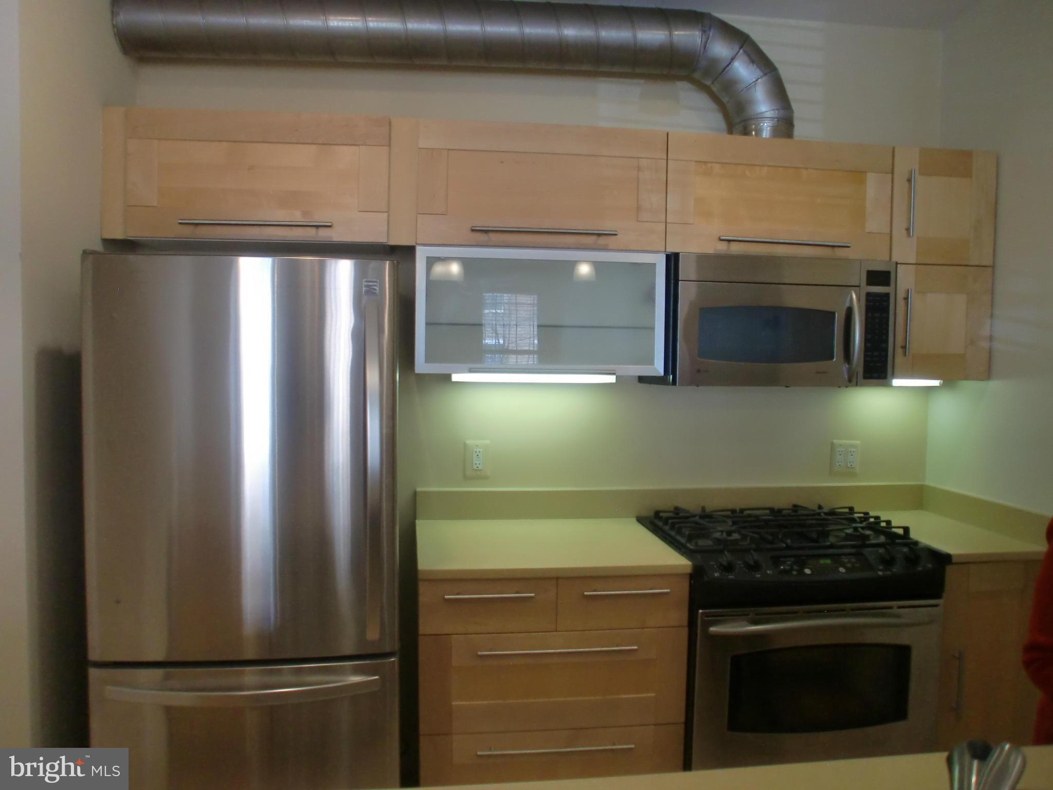 2434 Ontario Road Northwest, Unit 2 Washington, DC 20009 - Photo 7 of 27 a kitchen with refrigerator and microwave