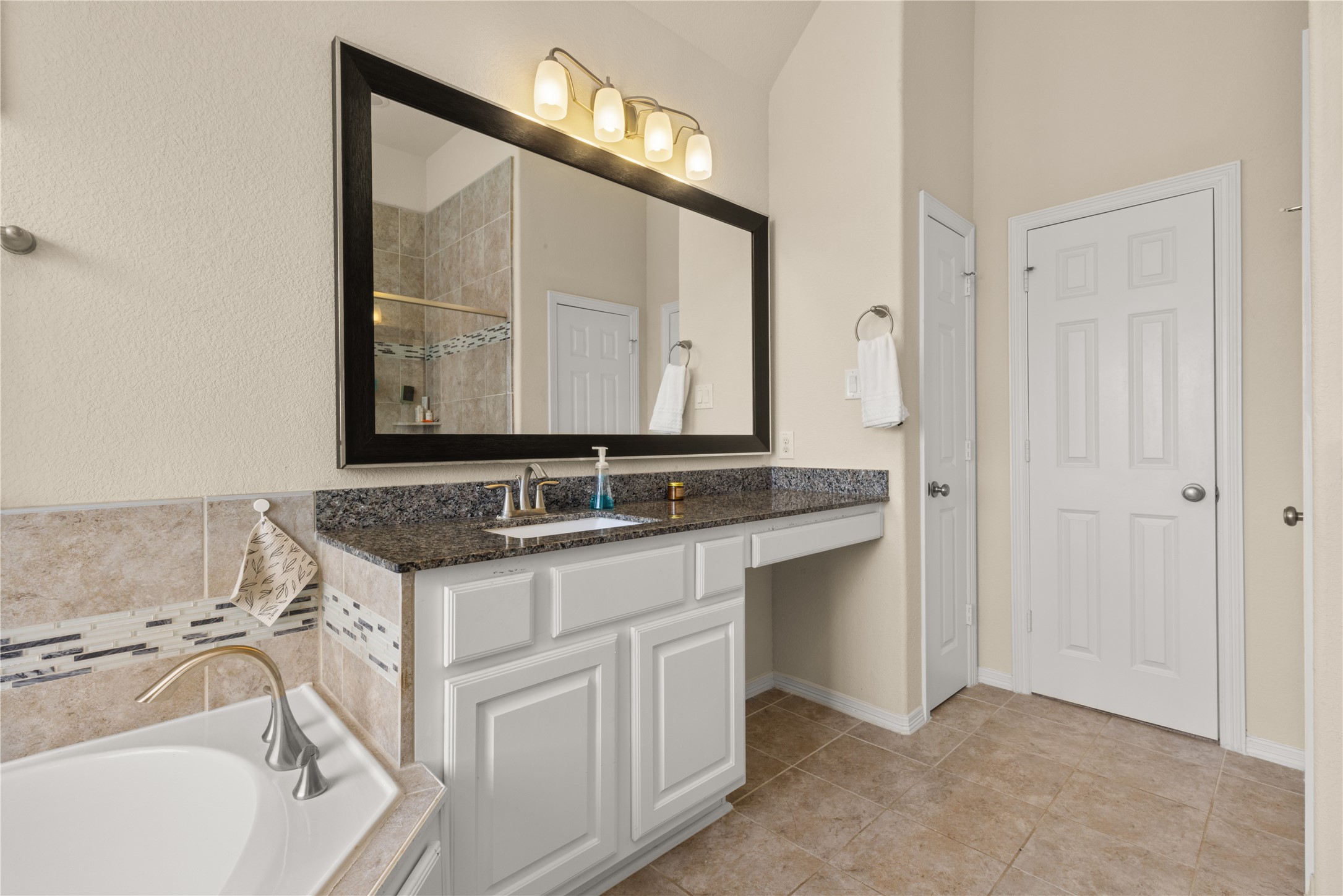 10204 Spring Shadows Park Circle Houston, TX 77080 - Photo 26 of 48 a bathroom with a sink and a mirror