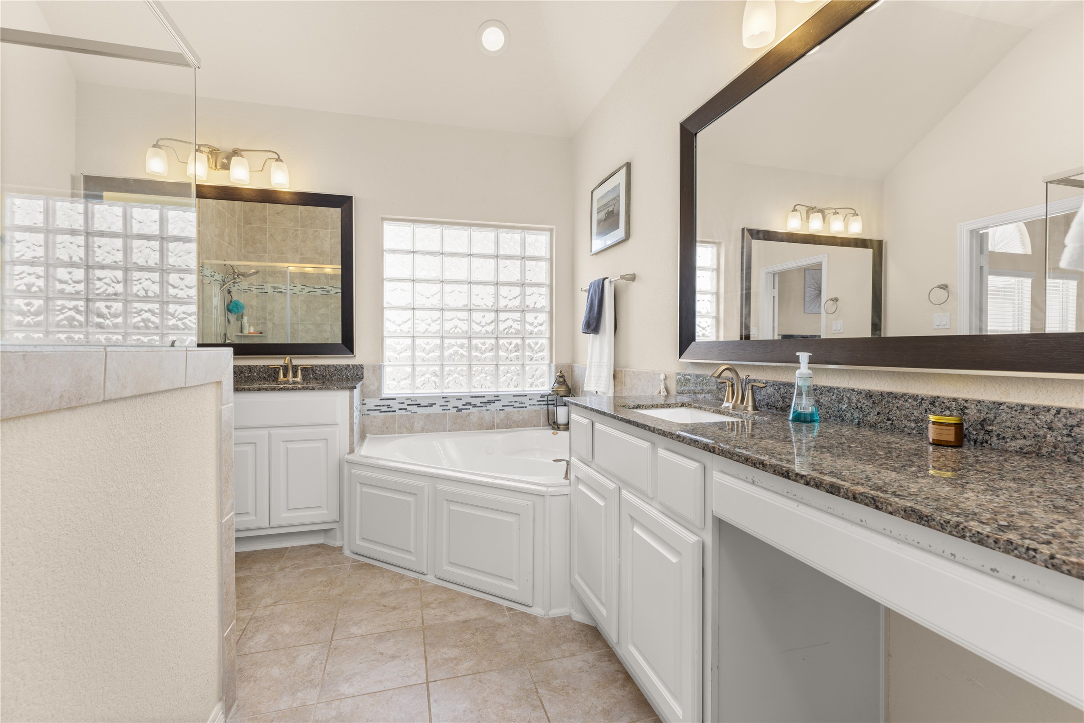 10204 Spring Shadows Park Circle Houston, TX 77080 - Photo 28 of 48 a bathroom with a granite countertop sink mirror and a bathtub
