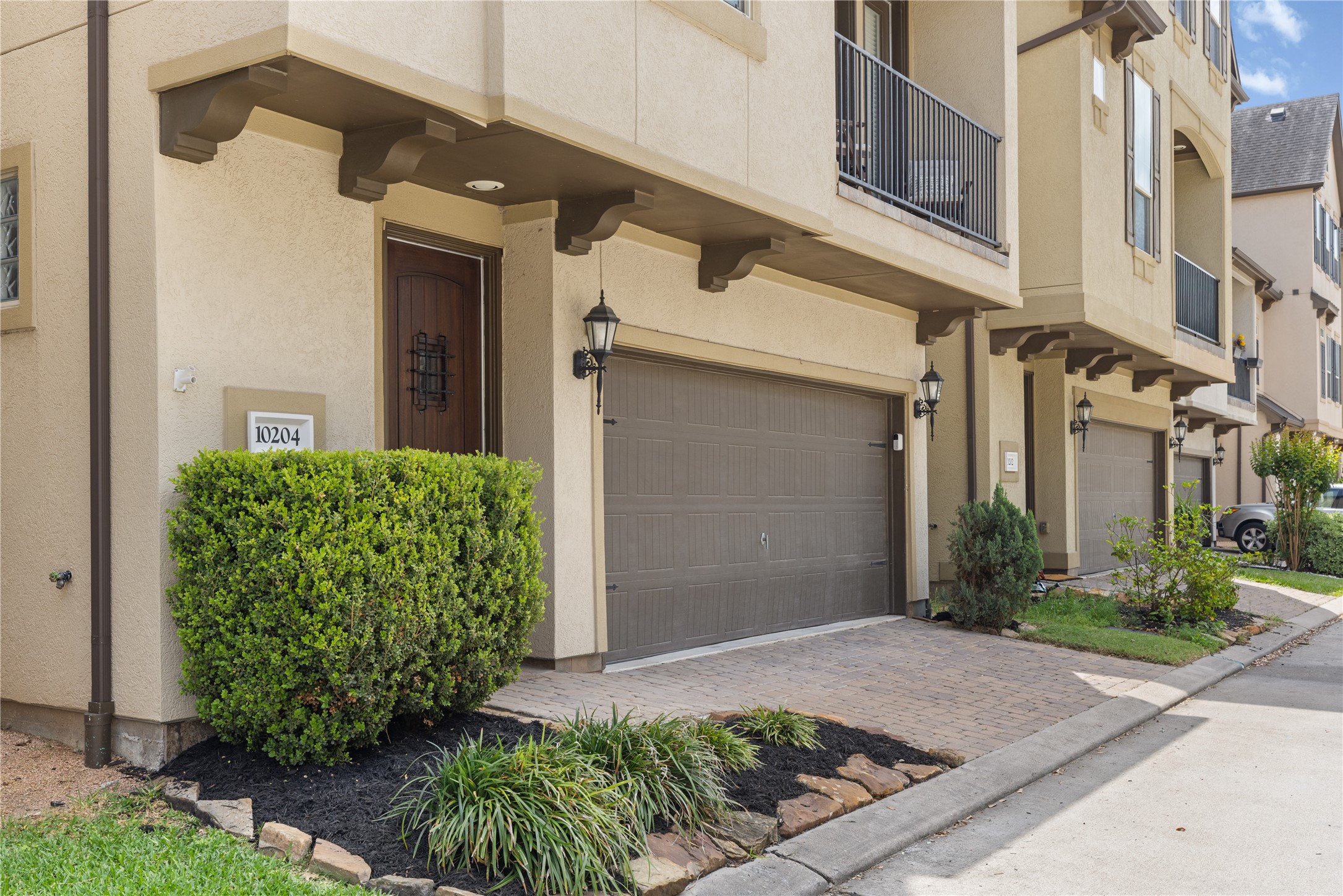 10204 Spring Shadows Park Circle Houston, TX 77080 - Photo 2 of 48 a front view of a house with garden