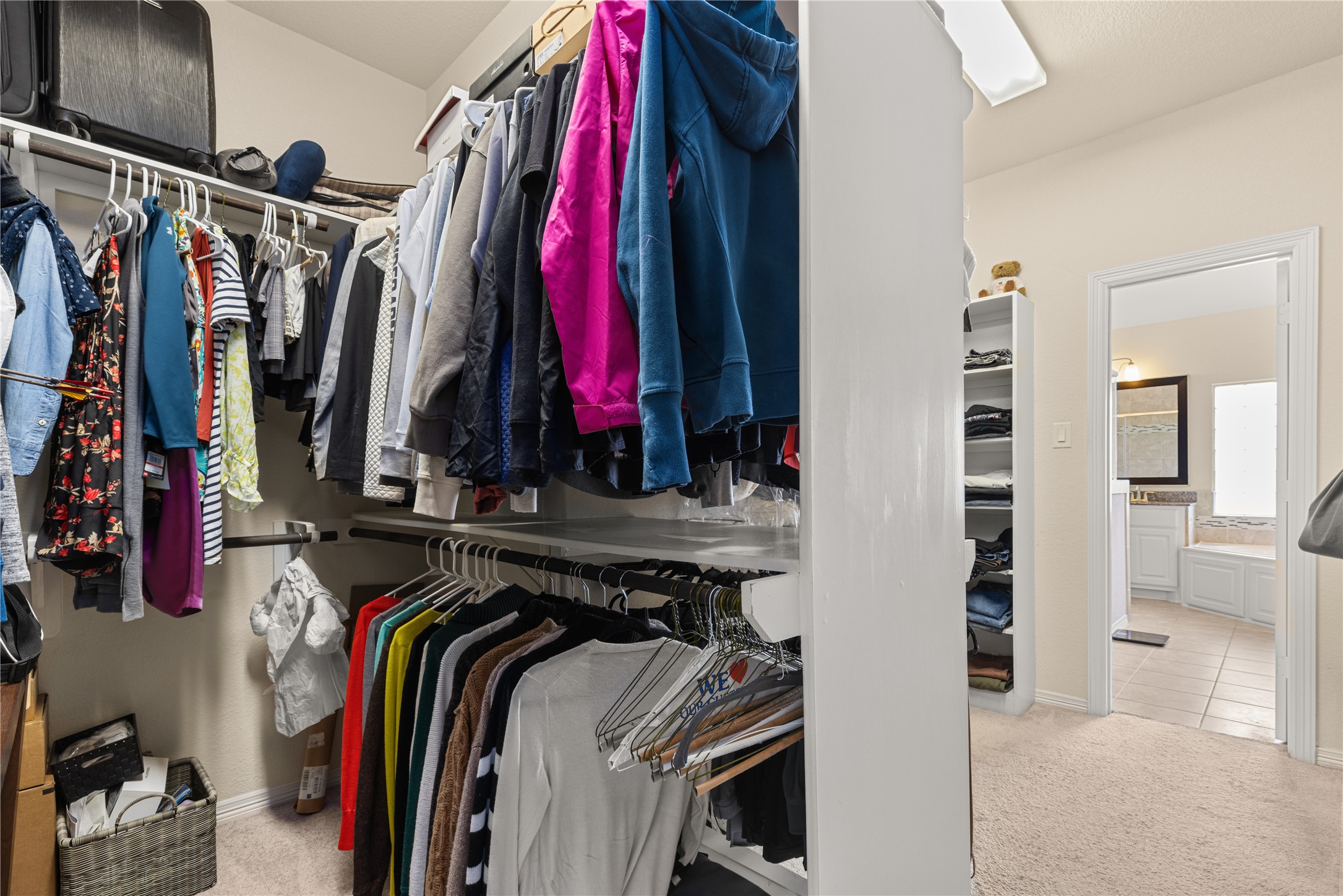 10204 Spring Shadows Park Circle Houston, TX 77080 - Photo 31 of 48 a view of walk in closet with clothes