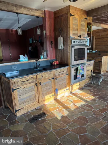 a kitchen with granite countertop a sink and cabinets
