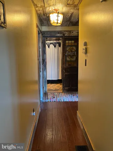 a view of a hallway with wooden floor