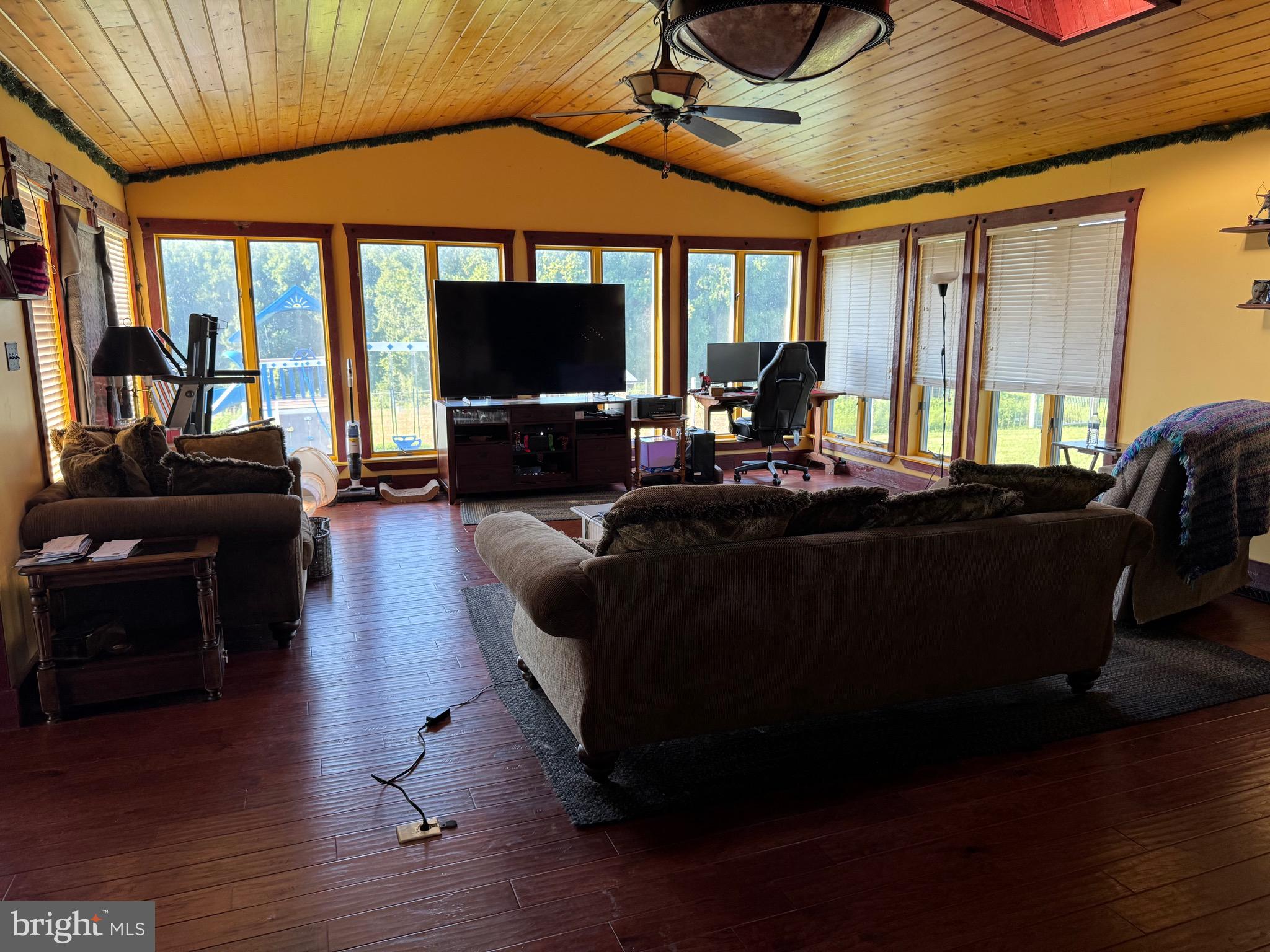 1089 Pond Neck Road Earleville, MD 21919 - Photo 9 of 34 a living room with furniture a flat screen tv and floor to ceiling window