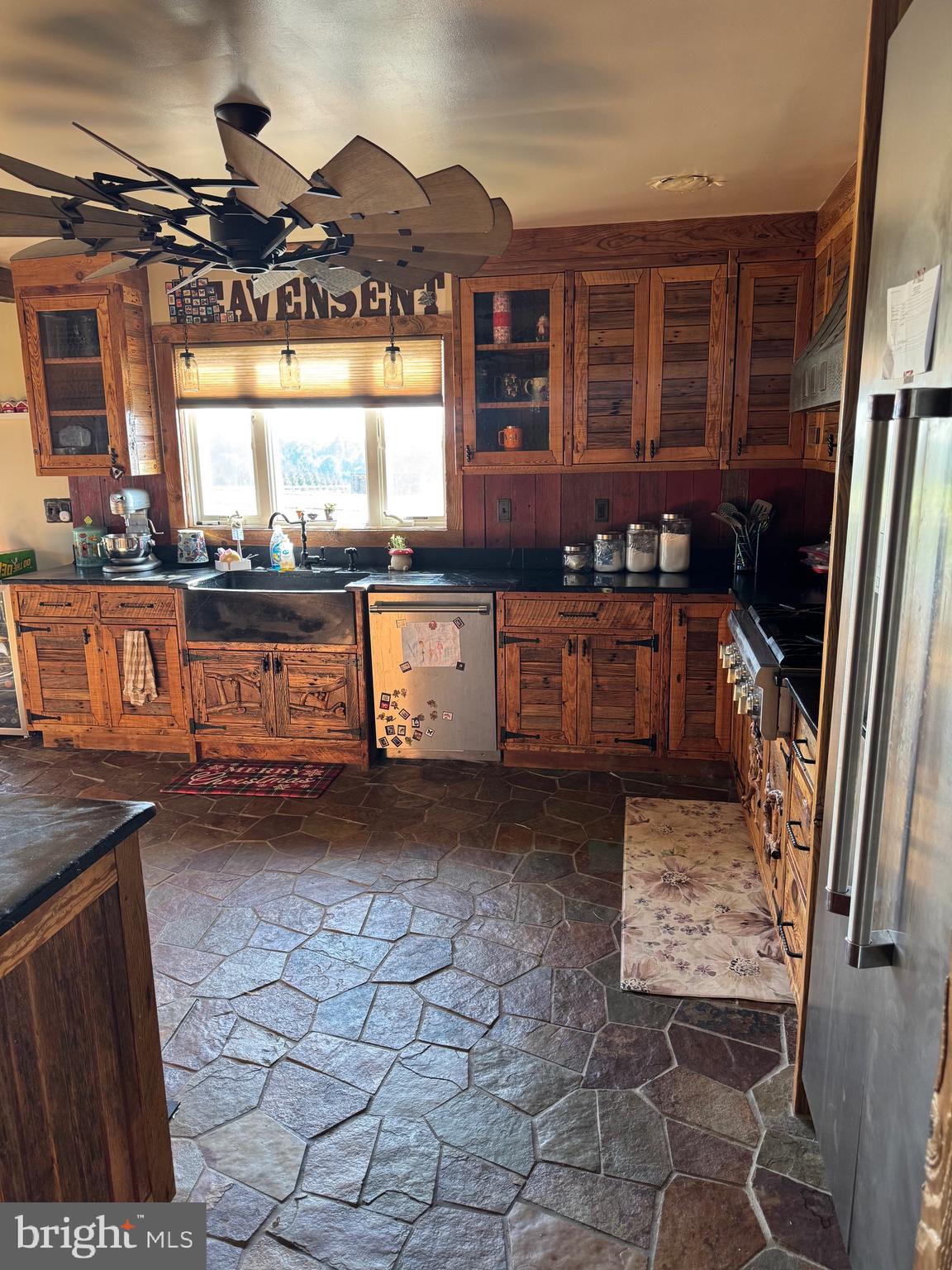1089 Pond Neck Road Earleville, MD 21919 - Photo 10 of 34 a kitchen with granite countertop a stove a sink and a microwave
