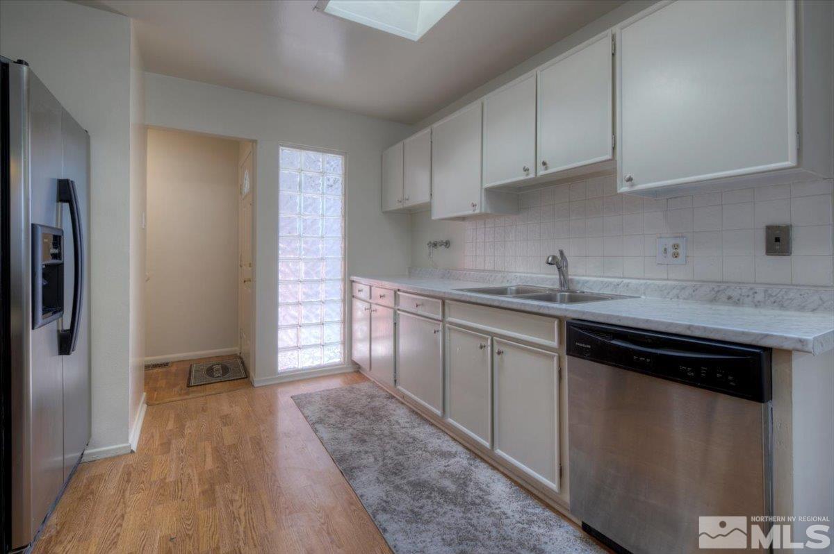 2821 Kings Row Reno, NV 89503 - Photo 6 of 27 a kitchen with stainless steel appliances granite countertop a stove a sink and a refrigerator
