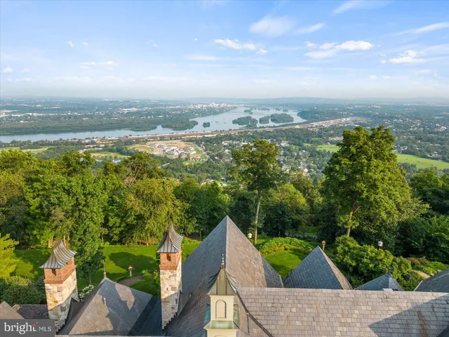a living room with fireplace furniture and a large window