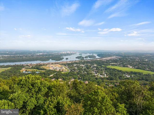 a living room with furniture a rug and a chandelier