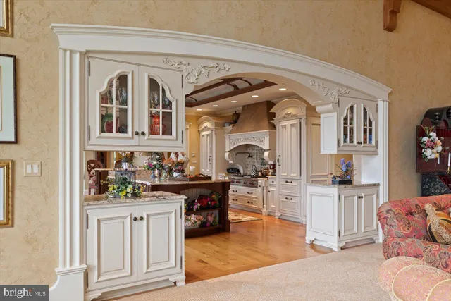 a living room with furniture fireplace and a large window