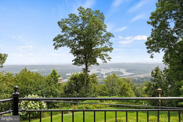 a living room with furniture a fireplace and a large window