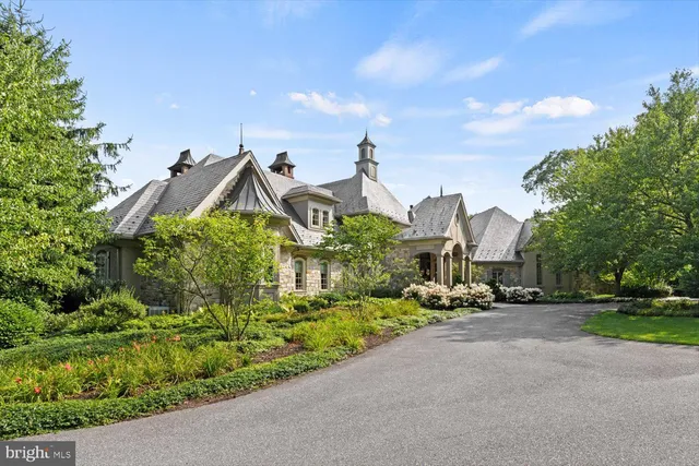 an aerial view of a house with a yard basket ball court and outdoor seating