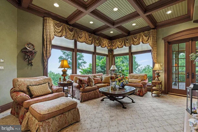 an aerial view of a house with garden space and trees all around