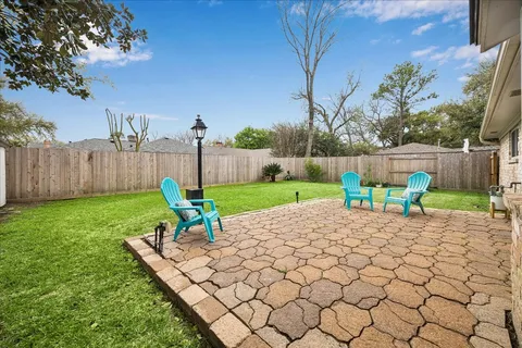 a view of a backyard with a table and chairs