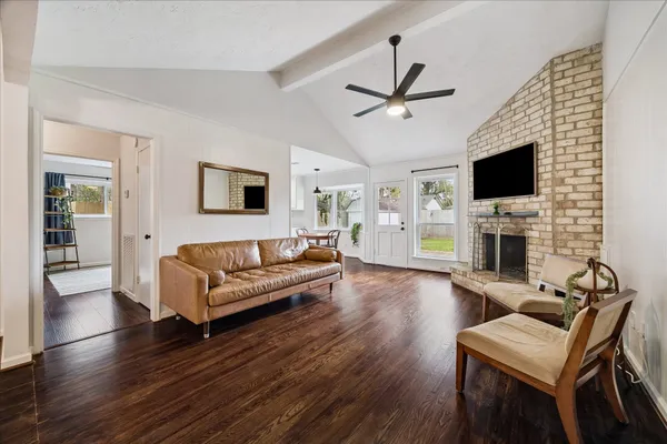 a living room with fireplace furniture and a wooden floor