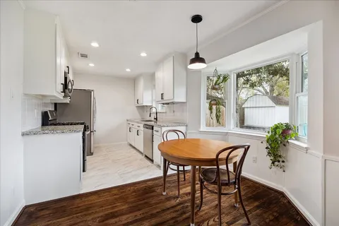 a dining room with furniture and window