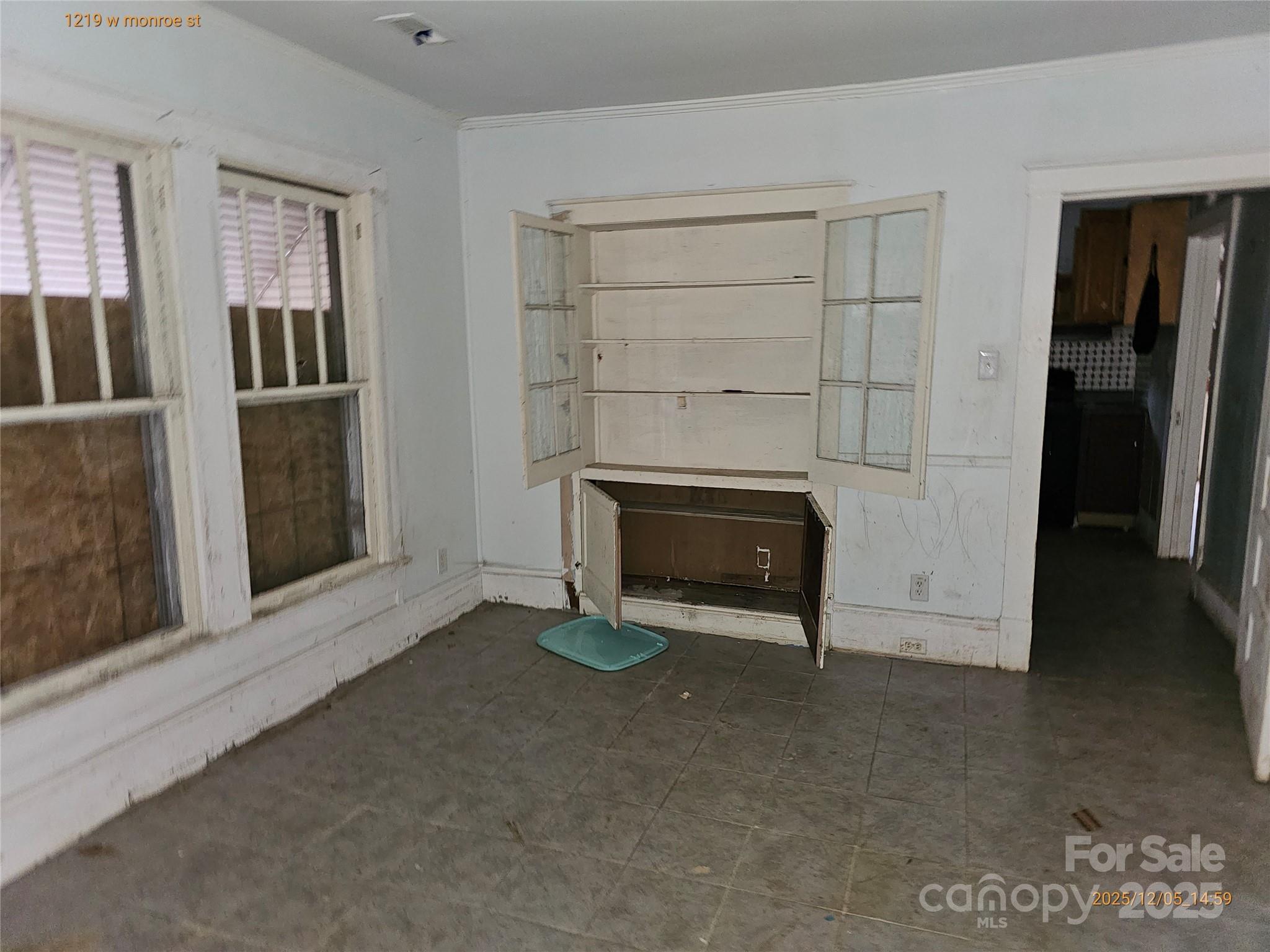 1219 West Monroe Street Salisbury, NC 28144 - Photo 9 of 15 a view of an empty room with a fireplace and a window