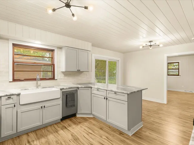 a kitchen with a sink cabinets and window