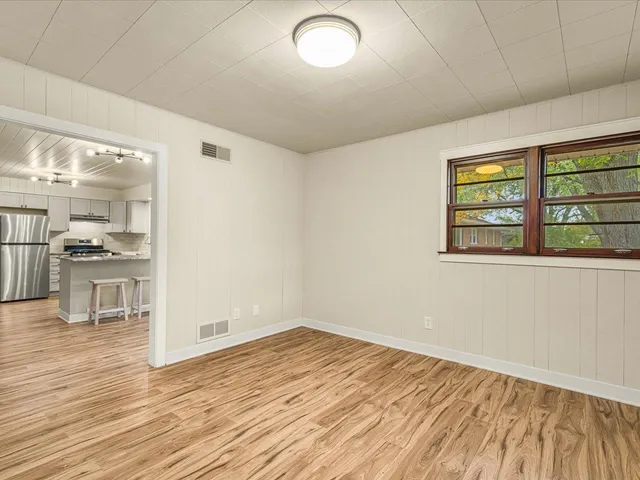 wooden floor in an empty room with a window