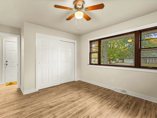 wooden floor in an empty room with a window