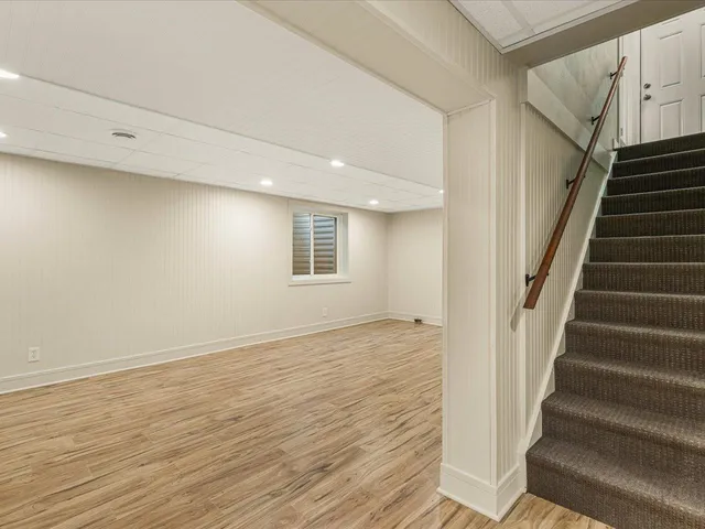 a view of an entryway with wooden floor