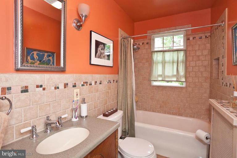 422 Kenneth Square Baltimore, MD 21212 - Photo 14 of 19 a bathroom with a granite countertop sink toilet and shower