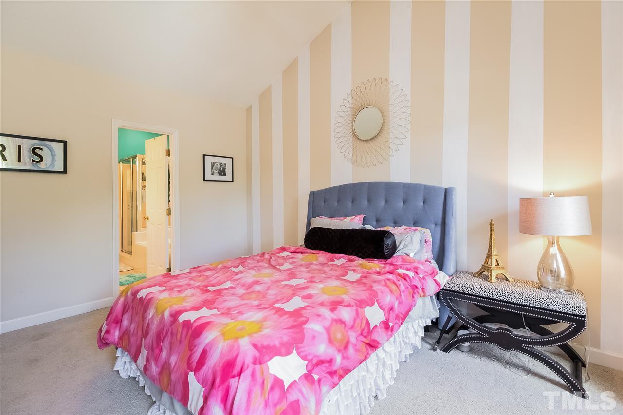 4201 Chelsford Place Raleigh, NC 27604 - Photo 13 of 24 a bedroom with a bed and a lamp