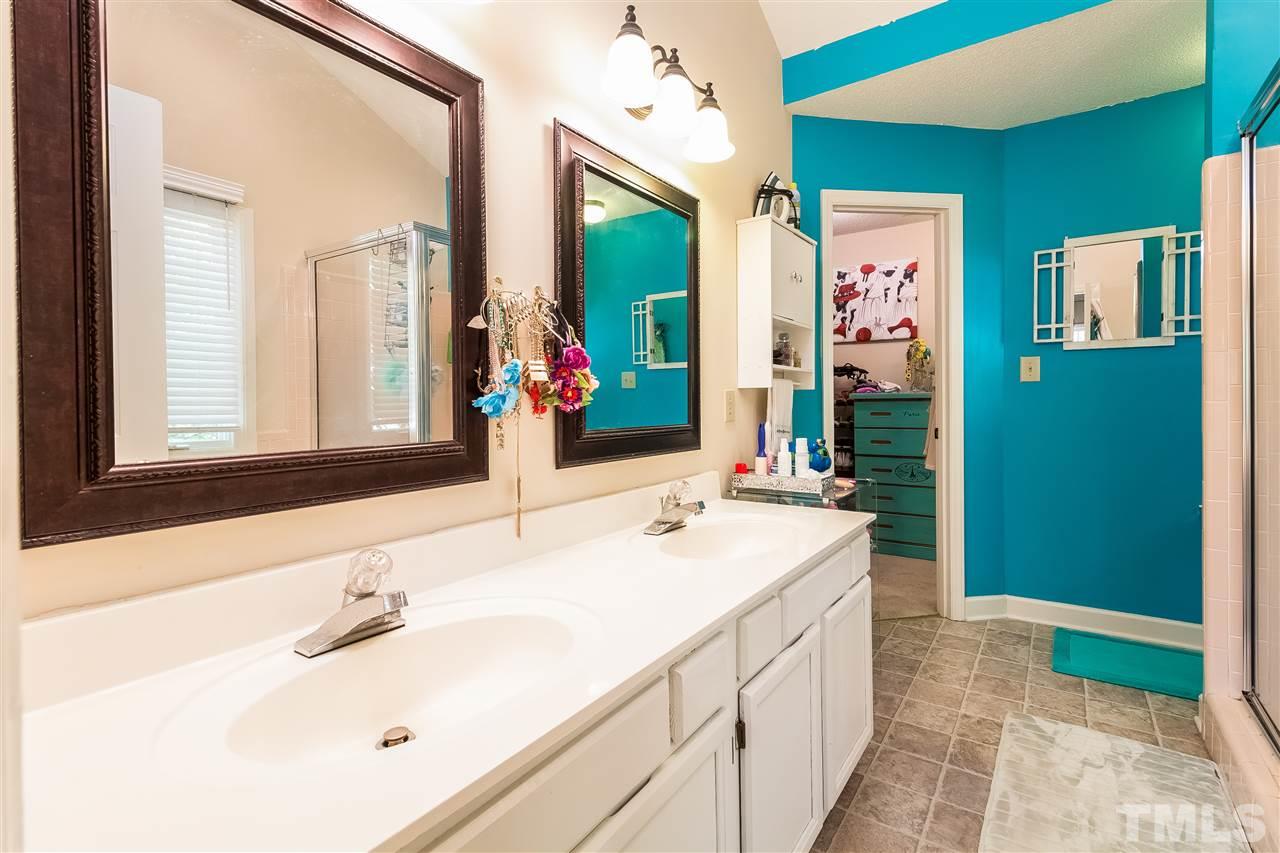 4201 Chelsford Place Raleigh, NC 27604 - Photo 14 of 24 a bathroom with a sink vanity and mirror